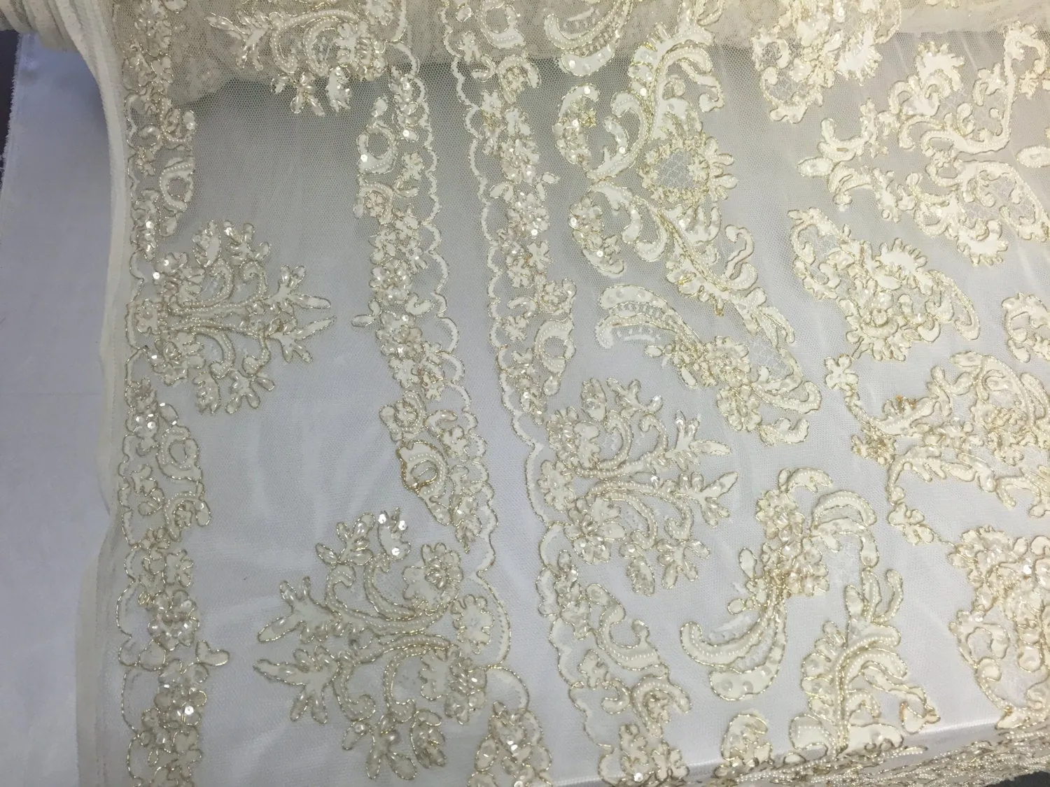 Ivory/metallic gold french design embroider and hand beaded with pearls ans sequins on a mesh lace-dresses-fashion-apparel-Sold by the yard.